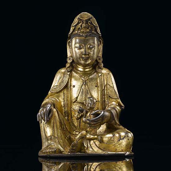 A GILT-BRONZE GROUP OF AVALOKITESHVARA (GUANYIN) WITH CHILD