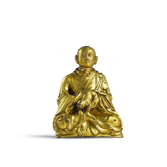 A GILT-BRONZE FIGURE OF A LAMA