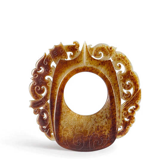 A RUSSET JADE SHE-SHAPED PLAQUE